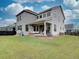 Expansive backyard featuring a covered patio and well-maintained lawn, perfect for outdoor activities and relaxation at 11246 Bellsong Ln, Littleton, CO 80125