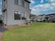 Beautifully landscaped backyard with green grass, a sandbox and backyard seating at 11246 Bellsong Ln, Littleton, CO 80125