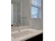 Modern bathroom with a double vanity, stylish fixtures, and natural light at 11246 Bellsong Ln, Littleton, CO 80125