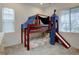 Charming bedroom featuring a bunk bed with a playful slide and tent-like canopy at 11246 Bellsong Ln, Littleton, CO 80125