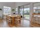 Bright dining room with a large wooden table, plenty of natural light, and views of the backyard at 11246 Bellsong Ln, Littleton, CO 80125