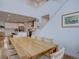 Bright dining room with wooden table, chairs, hardwood floors, plenty of natural light, and views of the kitchen at 11246 Bellsong Ln, Littleton, CO 80125