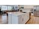Modern kitchen with a large center island, stainless steel appliances, and a seamless flow to the living area at 11246 Bellsong Ln, Littleton, CO 80125