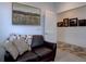 Cozy living room features a leather sofa and artwork on the wall at 11246 Bellsong Ln, Littleton, CO 80125