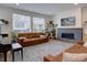 Cozy living room with a stone fireplace, stylish decor, and plenty of natural light at 11246 Bellsong Ln, Littleton, CO 80125