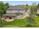 Rear aerial view of well-kept home featuring an outdoor living space and nicely landscaped yard at 10 Summit Ash, Littleton, CO 80127