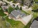 Backyard aerial view of home featuring a large patio with pergola and lush, green landscaping at 10 Summit Ash, Littleton, CO 80127