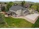 Aerial view showcasing home with expansive lawn, outdoor patio area, and three car garage at 10 Summit Ash, Littleton, CO 80127