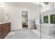 Bright bathroom with a soaking tub under a skylight and a view into the main bedroom at 10 Summit Ash, Littleton, CO 80127
