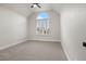 Bedroom with a large window and a ceiling fan, offering plenty of natural light at 10 Summit Ash, Littleton, CO 80127