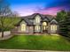 Beautiful two-story home with a manicured lawn, stone accents, and a welcoming front entrance at 10 Summit Ash, Littleton, CO 80127