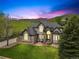 Stunning two-story home with lush front lawn, manicured landscaping, and mountain views at 10 Summit Ash, Littleton, CO 80127