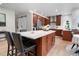 Modern kitchen with stainless steel appliances, custom cabinets, and a large center island at 10 Summit Ash, Littleton, CO 80127