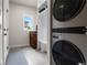 Well-organized laundry room featuring a modern washer and dryer, as well as built-in shelves at 10 Summit Ash, Littleton, CO 80127