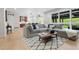Spacious living room with plush sectional sofa, large windows, and wood floors at 10 Summit Ash, Littleton, CO 80127