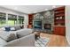 Cozy living room featuring a stone fireplace, custom built-ins, and comfortable seating at 10 Summit Ash, Littleton, CO 80127