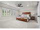 Serene main bedroom with neutral tones, a large window, and a luxurious bed at 10 Summit Ash, Littleton, CO 80127