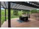 Outdoor patio area featuring brick flooring, a pergola, and a table with seating, overlooking the green space at 10 Summit Ash, Littleton, CO 80127