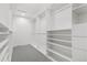 Large walk-in closet with built-in shelving and ample storage space throughout at 10 Summit Ash, Littleton, CO 80127
