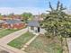 Charming home with well-kept lawn and mature tree, captured in an aerial perspective at 7001 Alan Dr, Denver, CO 80221