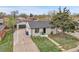 Aerial view of a charming single-Gathering home with a well-manicured lawn and a detached garage at 7001 Alan Dr, Denver, CO 80221