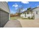 Backyard featuring a detached garage, chain-link fence and lush green lawn at 7001 Alan Dr, Denver, CO 80221