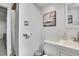 Clean bathroom featuring white fixtures and a shower with a stylish curtain. Neutral wall decor at 7001 Alan Dr, Denver, CO 80221