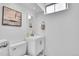 Bright bathroom featuring a white vanity with modern fixtures, clean lines, and neutral decor at 7001 Alan Dr, Denver, CO 80221