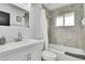 Clean, well-lit bathroom features a shower-over-tub combination with tile surround and modern vanity at 7001 Alan Dr, Denver, CO 80221
