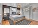 Comfortable bedroom with a plush king-sized bed, modern rug, and ample natural light from two windows at 7001 Alan Dr, Denver, CO 80221
