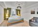 Well-lit room features a bed, comfortable seating, and ample space, providing a relaxing environment at 7001 Alan Dr, Denver, CO 80221