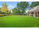 Expansive backyard with lush green lawn and mature trees surrounding the property at 3450 E Easter Ave, Centennial, CO 80122