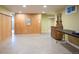 Unfinished basement area with wood paneling and a vintage dresser, offering plenty of space for storage at 3450 E Easter Ave, Centennial, CO 80122