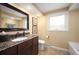 Well-lit bathroom with granite countertops, elegant fixtures, and tile flooring at 3450 E Easter Ave, Centennial, CO 80122