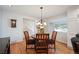 Cozy dining room with hardwood floors, chandelier, and a round table with four chairs at 3450 E Easter Ave, Centennial, CO 80122