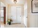 Bright foyer featuring neutral walls, tiled floor, sliding closet doors, and a white front door at 3450 E Easter Ave, Centennial, CO 80122