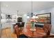 Open kitchen and dining area with wood floors, a central island, and a stylish chandelier at 3450 E Easter Ave, Centennial, CO 80122