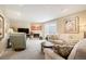 Cozy living room featuring a fireplace, plush seating, and a sliding glass door to the backyard at 3450 E Easter Ave, Centennial, CO 80122