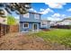 Exterior shot of a backyard with a well-manicured lawn, a wooden fence, and a blue house at 325 Mulberry Cir, Broomfield, CO 80020