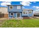 Exterior shot of a backyard with a well-manicured lawn, a wooden fence, and a blue house at 325 Mulberry Cir, Broomfield, CO 80020