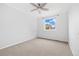 A bedroom features a ceiling fan and a large window offering a bright and inviting space at 325 Mulberry Cir, Broomfield, CO 80020