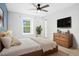 This primary bedroom features a wooden bed frame, and a blue accent wall at 325 Mulberry Cir, Broomfield, CO 80020