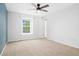 This bedroom features neutral carpet and a blue accent wall at 325 Mulberry Cir, Broomfield, CO 80020