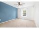 This bedroom features a blue accent wall and neutral carpet at 325 Mulberry Cir, Broomfield, CO 80020