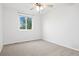 A bright bedroom with a ceiling fan and a large window offering ample natural light at 325 Mulberry Cir, Broomfield, CO 80020