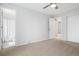 This bedroom features neutral carpet with multiple doors and closets at 325 Mulberry Cir, Broomfield, CO 80020