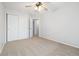 A large bedroom with a ceiling fan, neutral carpet, and a bright, open atmosphere at 325 Mulberry Cir, Broomfield, CO 80020