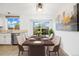 Staged dining area with white walls, stainless steel appliances, and ample natural light at 325 Mulberry Cir, Broomfield, CO 80020