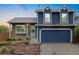 Charming two-story home with a blue exterior, complemented by landscaped front yard and a two car garage at 325 Mulberry Cir, Broomfield, CO 80020
