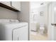 Bright laundry area with modern washer and dryer conveniently located off the bathroom at 325 Mulberry Cir, Broomfield, CO 80020